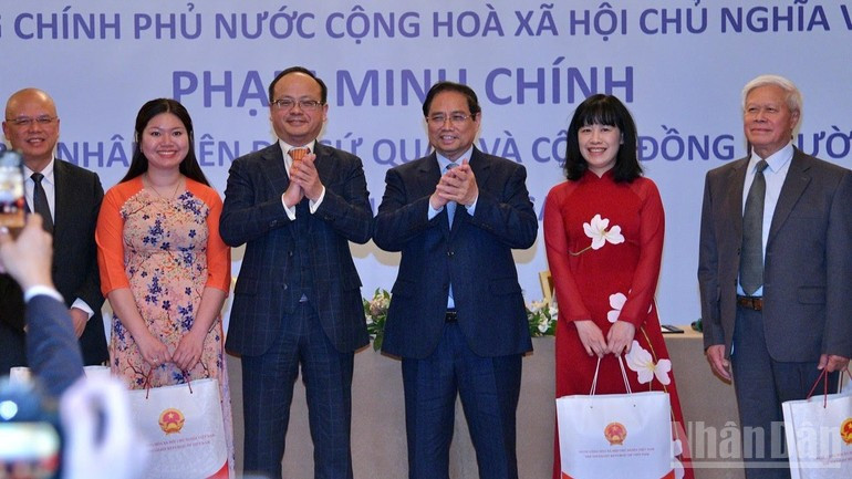 El primer ministro Pham Minh Chinh (centro) presenta regalos a la comunidad vietnamita en Rusia en la reunión en Moscú el 22 de marzo (hora local). (Foto: Nhan Dan)