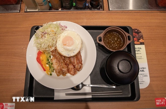 El plato "Arroz partido vietnamita con cerdo" (Foto: VNA)