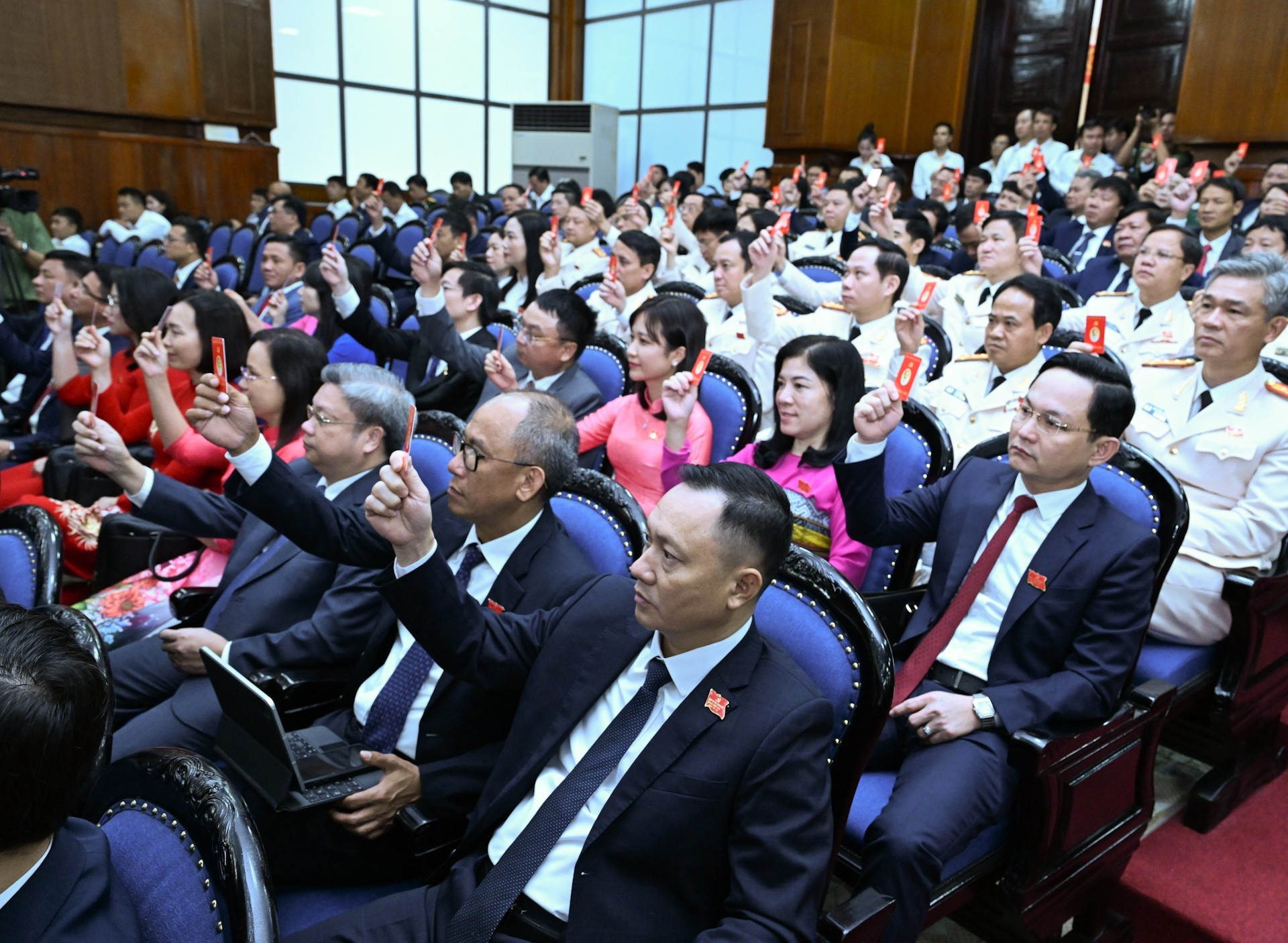 Los delegados votan por aprobar la agenda del evento.