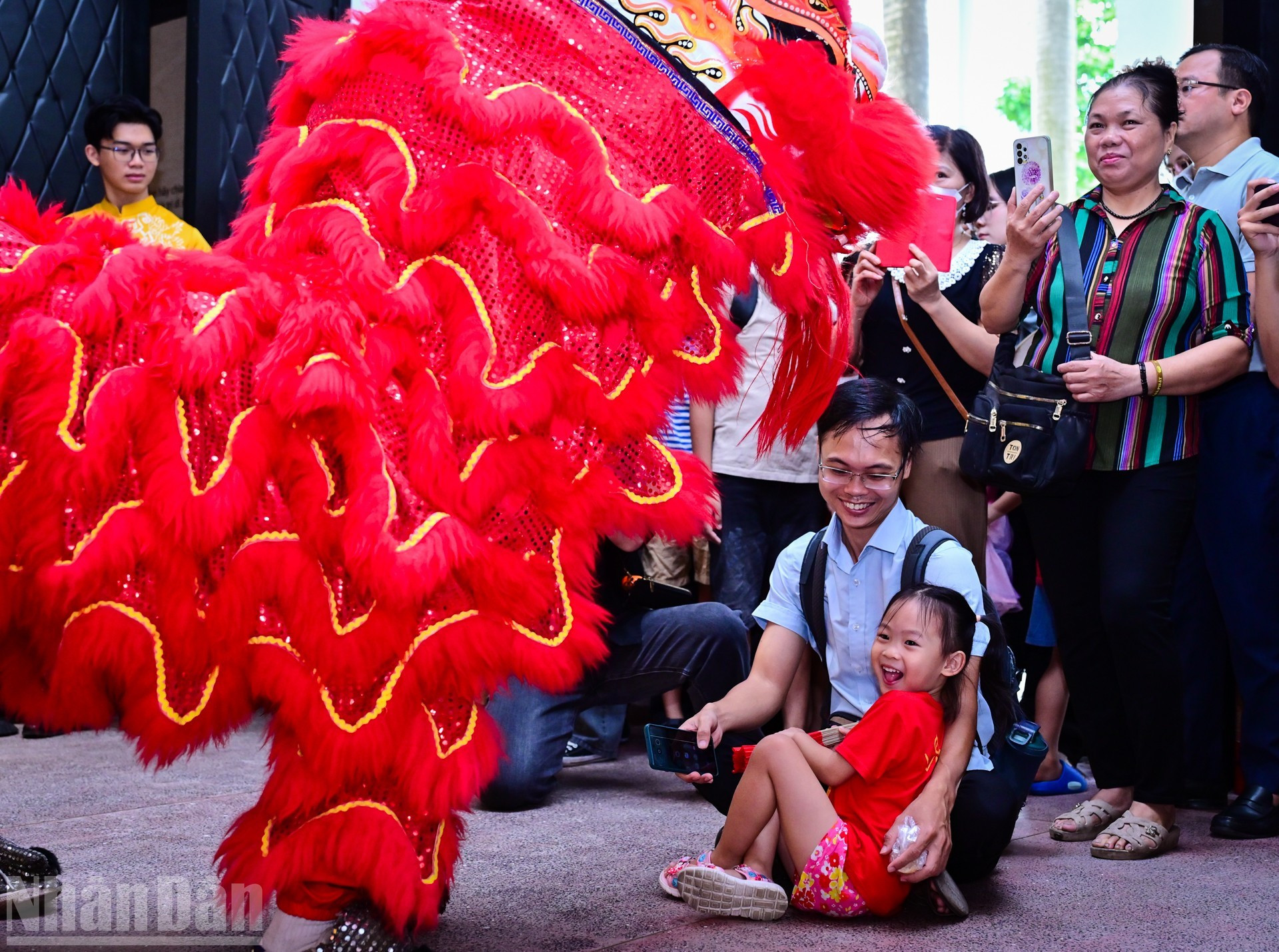 Los niños disfrutan de la actuación de la danza del león.