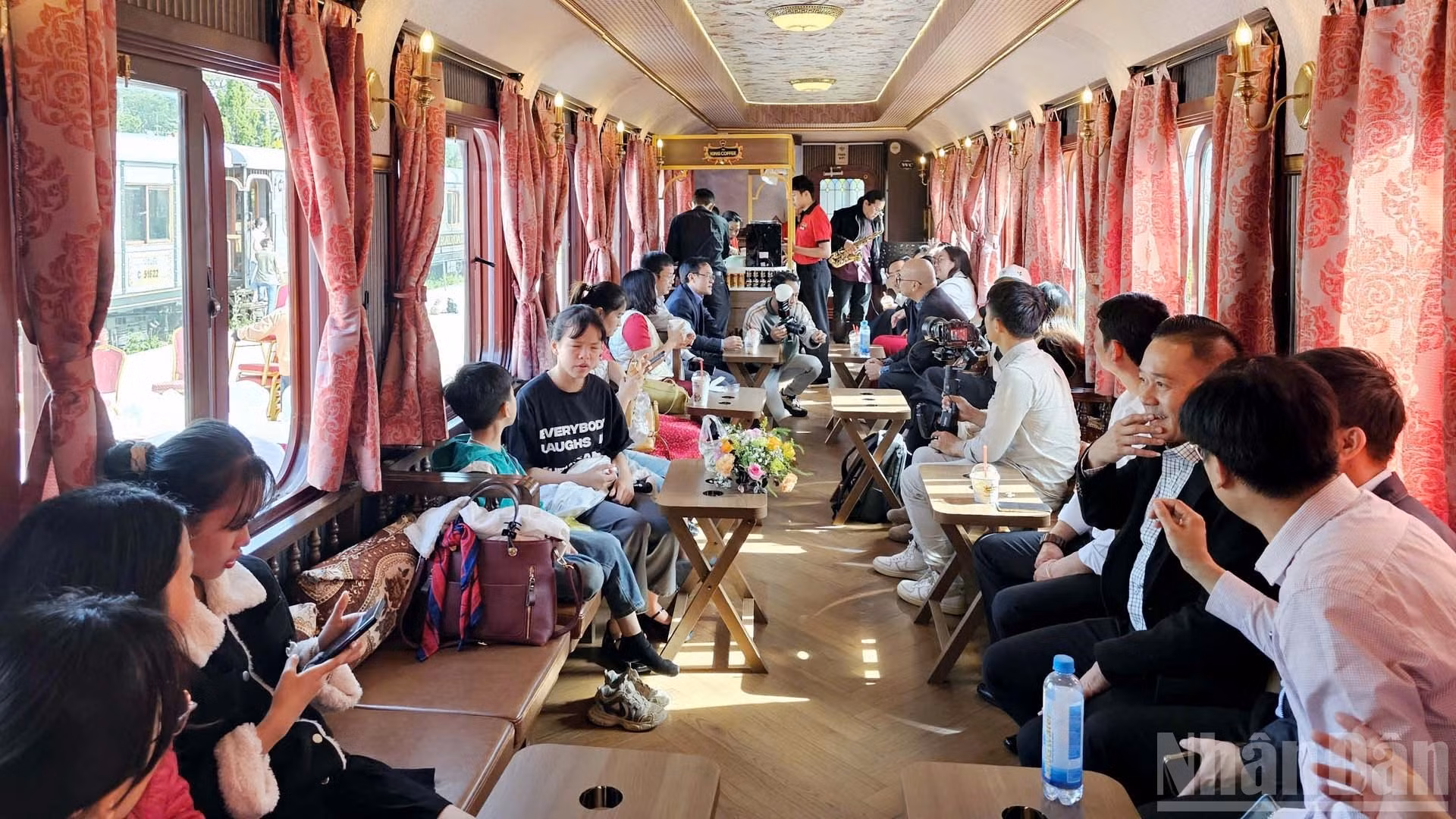 Los turistas disfrutan del café vietnamita y de la música en los vagones antiguos del Tren del Café de Da Lat.