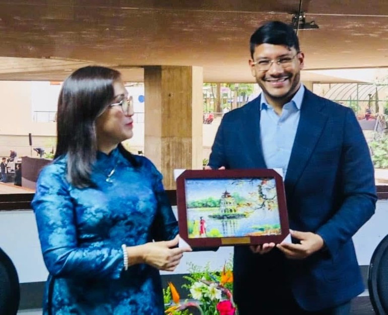 Dinh Thi Mai, subjefa de la Comisión de Propaganda y Movilización de Masas del Comité Central del PCV, entrega un regalo a Rander Peña, vicepresidente encargado de Asuntos Internacionales del PSUV. (Foto: Embajada de Vietnam en Venezuela) Dinh Thi Mai, subjefa de la Comisión de Propaganda y Movilización de Masas del Comité Central del PCV, entrega un regalo a Rander Peña, vicepresidente encargado de Asuntos Internacionales del PSUV. (Foto: Embajada de Vietnam en Venezuela)