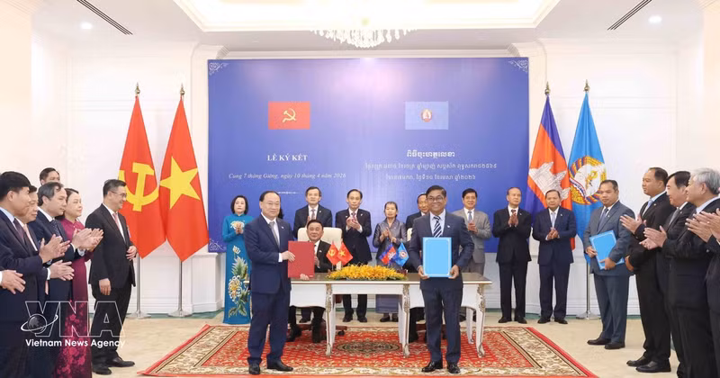 El miembro del Buró Político y miembro permanente del Secretariado del Comité Central del Partido Comunista de Vietnam, Tran Cam Tu, y el vicepresidente del Partido Popular de Camboya (CPP) y jefe del Comité Permanente del Comité Central del CPP, Say Chhum, presencian en Phnom Penh la entrega de documentos de cooperación. (Foto: VNA)