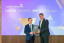 Le Hoang Tung, subdirector general de Vietcombank (izquierda), recibe el certificado de Sumit Kamra, director de desarrollo estratégico de Kantar Insights. (Foto: VNA)