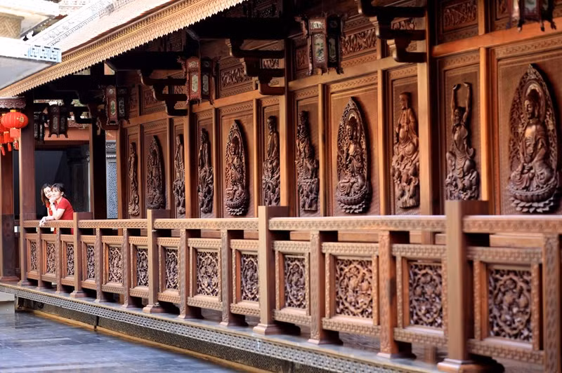 Las paredes y puertas de madera están talladas meticulosamente, con imágenes de budas. Las paredes y puertas de madera están talladas meticulosamente, con imágenes de budas.