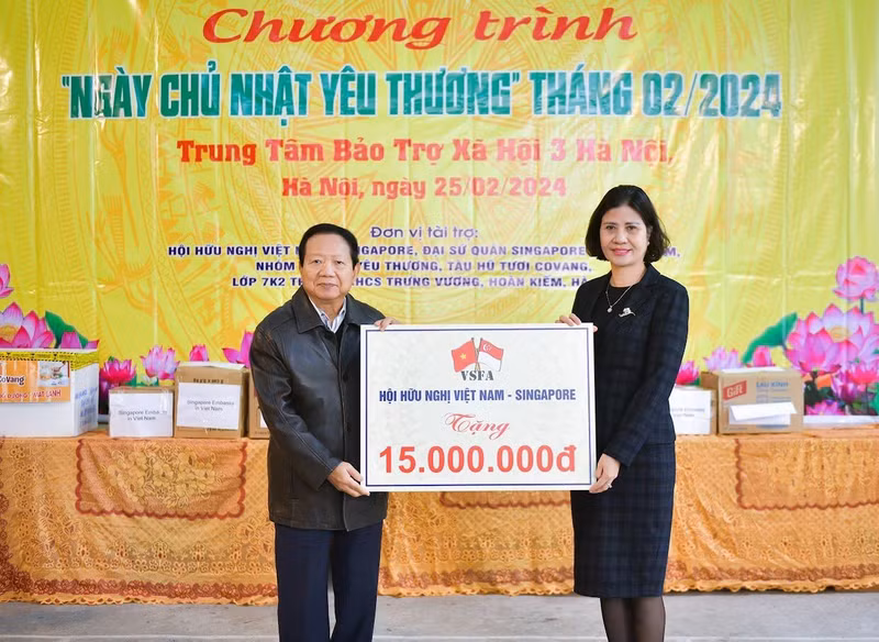 El embajador Nguyen Duc Hung, secretario general de la Asociación de Amistad Vietnam-Singapur, entrega una asistencia financiera de más de 600 dólares al Centro.