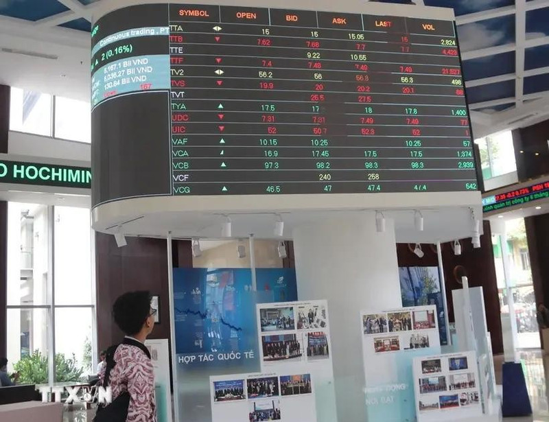Los inversores monitorean las listas de precios de las acciones en la bolsa de valores de Ciudad Ho Chi Minh- HOSE (Fuente: VNA)