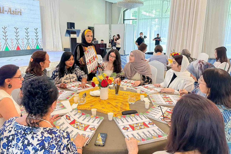 La esposa del embajador árabe, Hiba Mostafa S.Mahros, presenta el arte Al-Qatt Al-Asiri. 