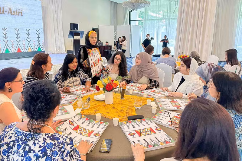La esposa del embajador árabe, Hiba Mostafa S.Mahros, presenta el arte Al-Qatt Al-Asiri. 