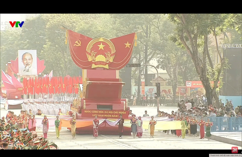 Caravana con el modelo del Escudo Nacional de la República Socialista de Vietnam desfilando frente a la tribuna. (Foto: VNA)