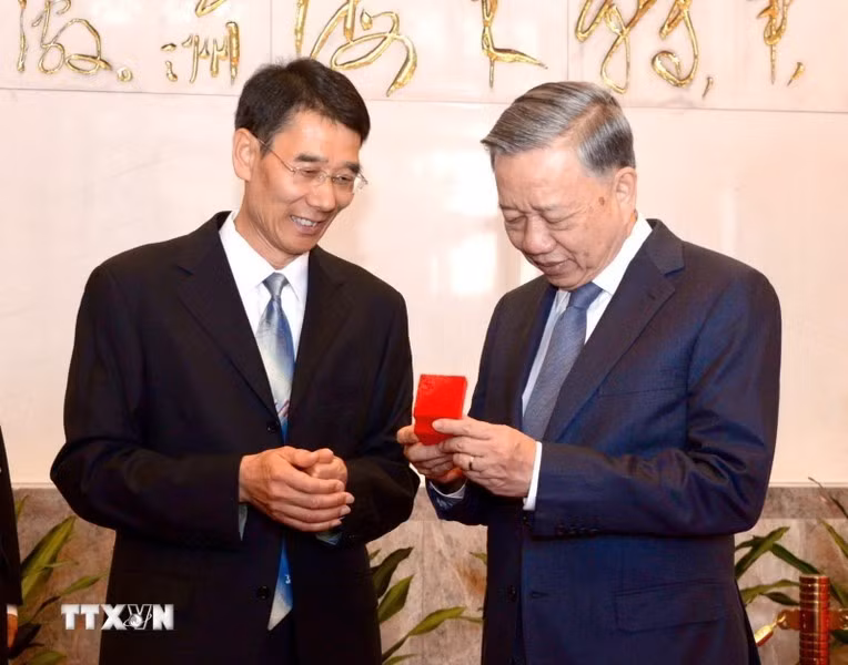 Un representante de la junta directiva de la Casa Conmemorativa de Mao Zedong presenta un recuerdo al líder vietnamita. (Foto: VNA)