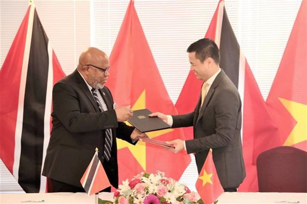 El embajador Dang Hoang Giang, representante de Vietnam ante las Naciones Unidas, y su homólogo de Trinidad & Tobago, Dennis Francis, en nombre de los gobiernos de cada país, firmaron un Comunicado conjunto para establecer los nexos diplomáticos entre las dos naciones, en Nueva York. (Fotografía: VNA)