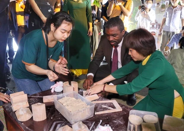 Un turista experimenta la fabricación de flechas de arcilla en la noche de apertura del Festival de Turismo de Hanói 2023. (Foto: VNA)