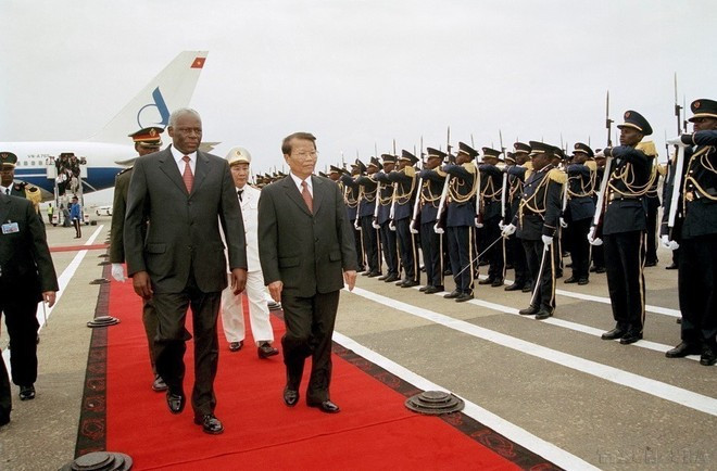 El presidente de Angola, José Eduardo dos Santos, y su homólogo vietnamita Tran Duc Luong pasan revista a la guardia de honor en el aeropuerto internacional 4/2 de la capital Luanda, durante la visita oficial de Duc Luong al país africano del 25 al 26 de octubre de 2002.