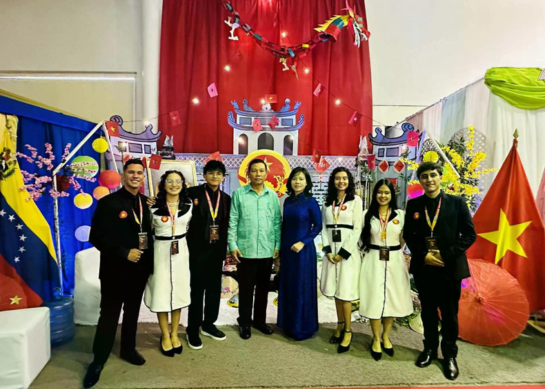 El embajador Vu Trung My (de camisa turquesa) y estudiantes que ayudan con la instalación del espacio “Vietnam: el país y la gente”. (Fotografía: baoquocte.vn) El embajador Vu Trung My (de camisa turquesa) y estudiantes que ayudan con la instalación del espacio “Vietnam: el país y la gente”. (Fotografía: baoquocte.vn)