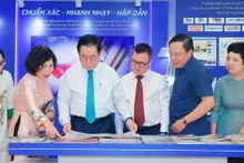 Nguyen Trong Nghia (tercero desde izquierda), miembro del Buró Político, secretario del Comité Central del Partido Comunista de Vietnam y jefe de su Comisión de Información, Educación y Movilización de Masas, visita el stand de la Agencia vietnamita de Noticias (Fuente: VNA)