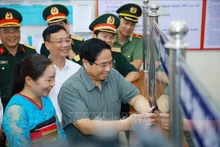 El primer ministro de Vietnam, Pham Minh Chinh, inspecciona el trabajo en el centro de servicios administrativos públicos de la comuna de Bat Mot, provincia de Thanh Hoa. (Foto: VNA)