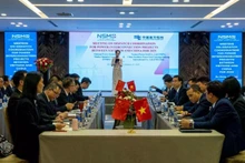 Vista de la Conferencia sobre la coordinación de la operación de la red eléctrica interconectada Vietnam-China.