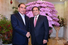 El primer ministro Pham Minh Chinh felicita al ex secretario general del Partido Comunista de Vietnam Nong Duc Manh.