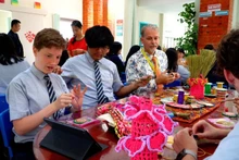 Estudiantes de séptimo a duodécimo grado de diferentes nacionalidades practican el arte del bordado a mano tradicional de los vietnamitas. (Fotografía: Nhan Dan)