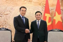 El integrante del Buró Político y miembro permanente del Secretariado del Comité Central del Partido Comunista de Vietnam, Tran Cam Tu (derecha), recibe al jefe interino de la Comisión de Asuntos Exteriores del Comité Central del Partido Popular Revolucionario de Laos, Bounleua Phandanouvong. (Fotografía: VNA)