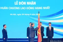 En nombre del Partido y del Estado, el secretario general del Partido Comunista de Vietnam, To Lam, otorga la Orden de Trabajo de primera clase al Ministerio de Ciencia y Tecnología por sus logros excepcionales. (Foto: Nhan Dan)