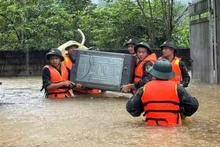 Oficiales y soldados de la Brigada 409 y del Alto Mando Militar de la provincia de Bac Ninh ayudan a los habitantes de la comuna de Xuan Luong a trasladar personas y bienes. (Foto: VNA)