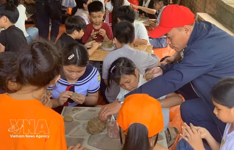 Los alumnos de la Escuela Primaria Phu My 1 experimentan la elaboración de cerámica en la aldea de alfarería de Phuoc Tich (ciudad de Hue). (Foto: VNA)