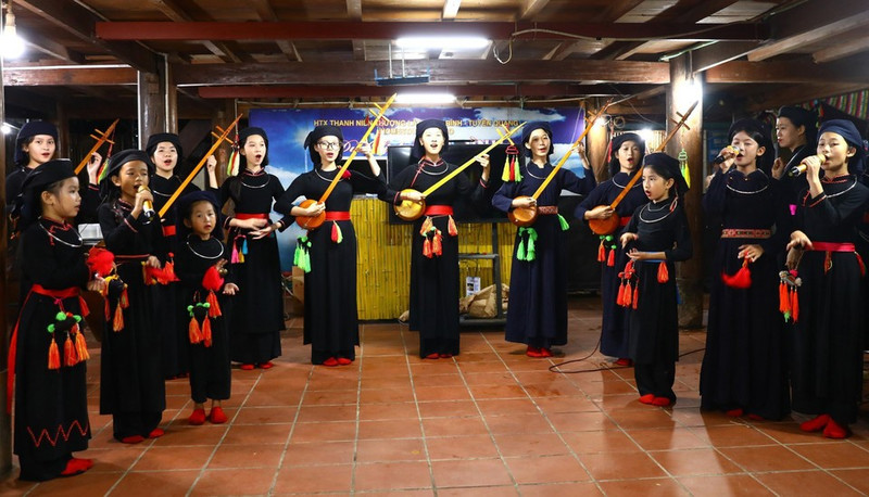 Presentación de cantos Then con laúd Tinh para visitantes en la casa de familia Tai Ngao, aldea de Na Tong, comuna de Thuong Lam. (Foto: VNA)
