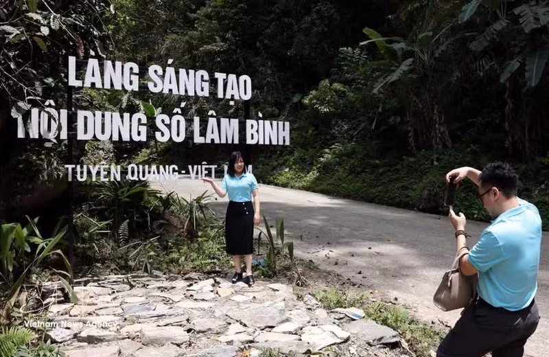 Turistas toman fotografías y realizan actividades de “check-in” en la Aldea de Creación de Contenidos Digitales de la comuna de Lam Binh. (Foto: VNA)