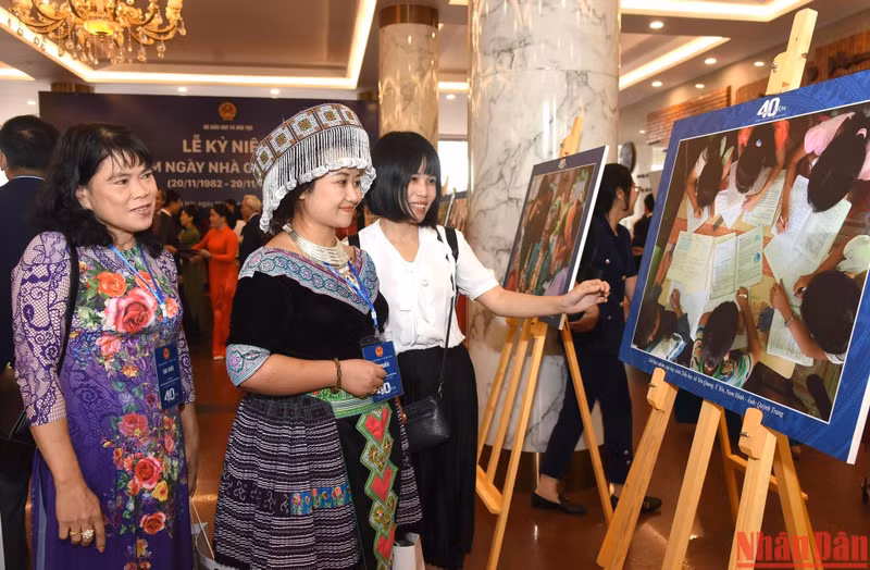 Los delegados visitan la exposición de fotografías en el evento.