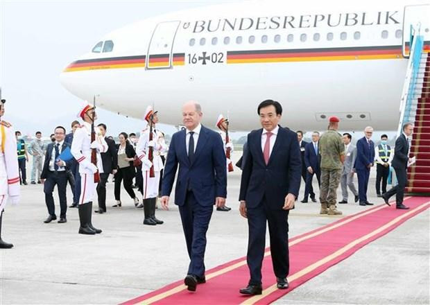 El canciller alemán Olaf Scholz (I) es recibido en el Aeropuerto Internacional Noi Bai en Hanói. (Fotografía: VNA)