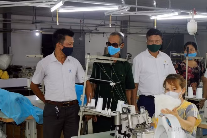 Nguyen Van Hung (izquierda) del pueblo de Duy Tien, de la provincia de Ha Nam, es un víctima directa del Agente Naranja tipo 2 (transmitido por su padre) se esfuerza por desarrollar su modelo de economía familiar. (Foto: VNA)