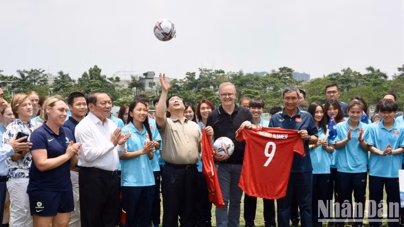 El primer ministro Pham Minh Chinh con el balón entregado por el cuerpo técnico y las jugadoras de la selección vietnamita de fútbol femenino.