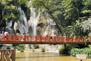 Turistas visitan la cascada de Kuang Si, uno de los destinos más emblemáticos de la provincia laosiana de Luang Prabang. (Foto: Le Duy Toan)