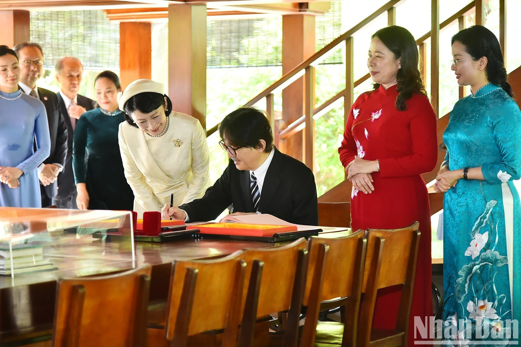 El príncipe japonés escribe en el libro de recuerdo en la casa sobre pilotes del tío Ho. El príncipe japonés escribe en el libro de recuerdo en la casa sobre pilotes del tío Ho.