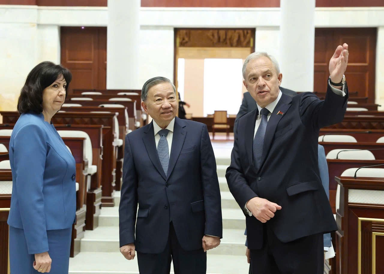 La presidenta del Consejo de la República, Natalya Kochanova, y el presidente de la Cámara de Representantes, Igor Sergeyenko, presentan al secretario general del PCV, To Lam, la sede del Parlamento de Bielorrusia.