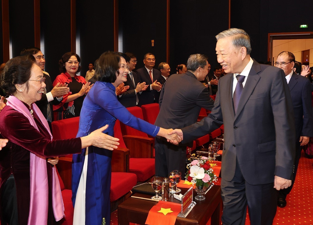 To Lam con los delegados en el acto.