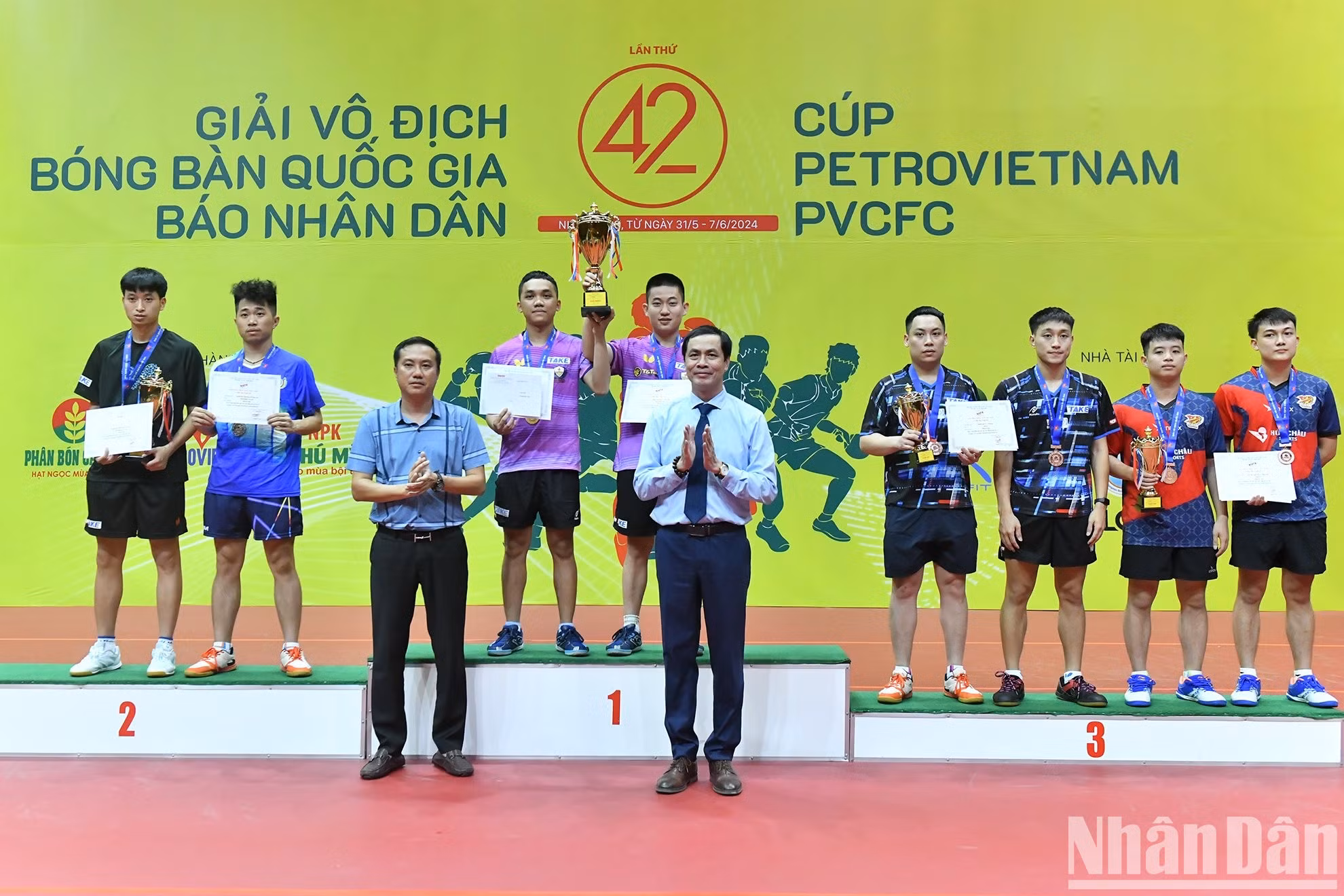 Tran Huu Viet y Nguyen Xuan Vu, presidente de la Federación de Tenis de Mesa de Vietnam, entregan medallas y trofeos a los ganadores de dobles masculinos.