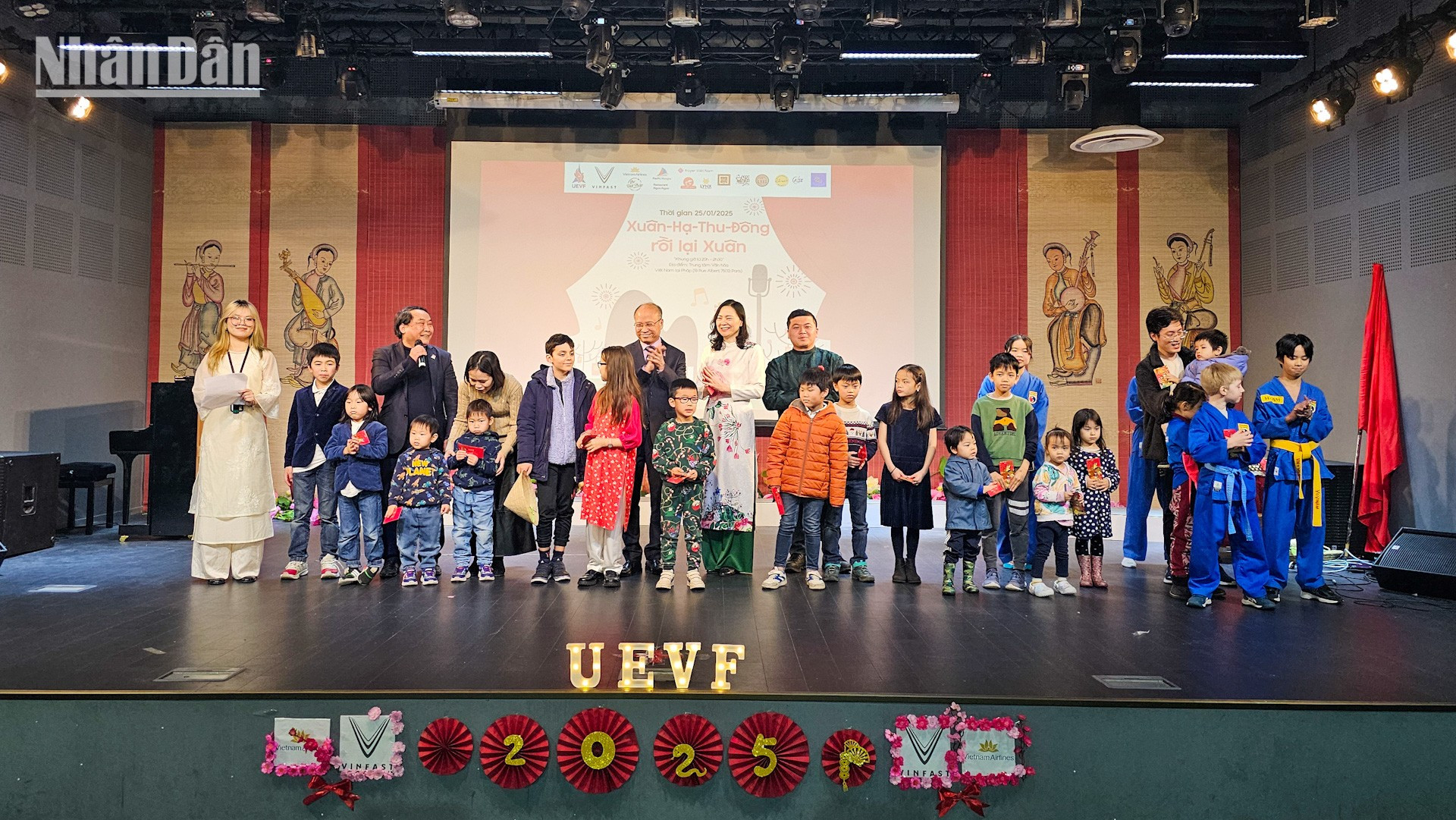 El embajador Dinh Toan Thang e invitados entregan dinero de suerte a niños.