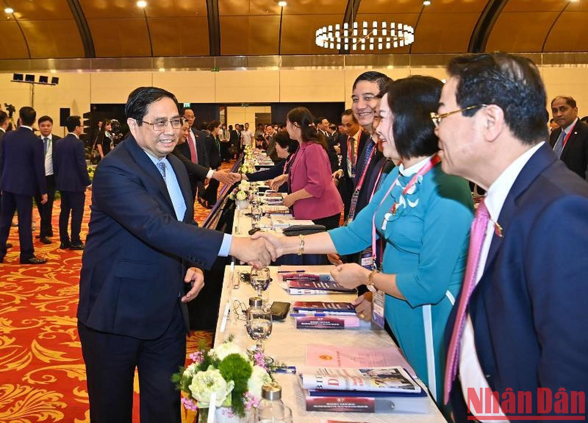 El primer ministro Pham Minh Chinh saluda a delegados al foro. El primer ministro Pham Minh Chinh saluda a delegados al foro.