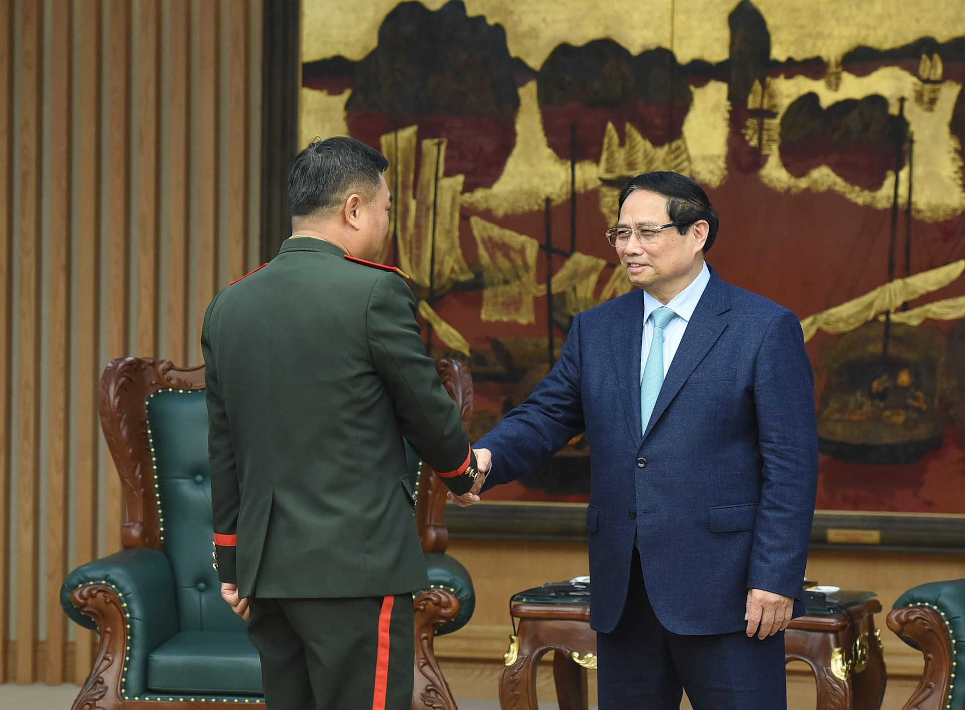 El primer ministro Pham Minh Chinh recibe al teniente general Saichay Kommasith, viceministro de Defensa y jefe del Estado Mayor General del Ejército Popular de Laos.