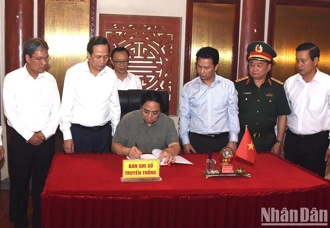 El dirigente escribe en el libro de visitas del sitio.