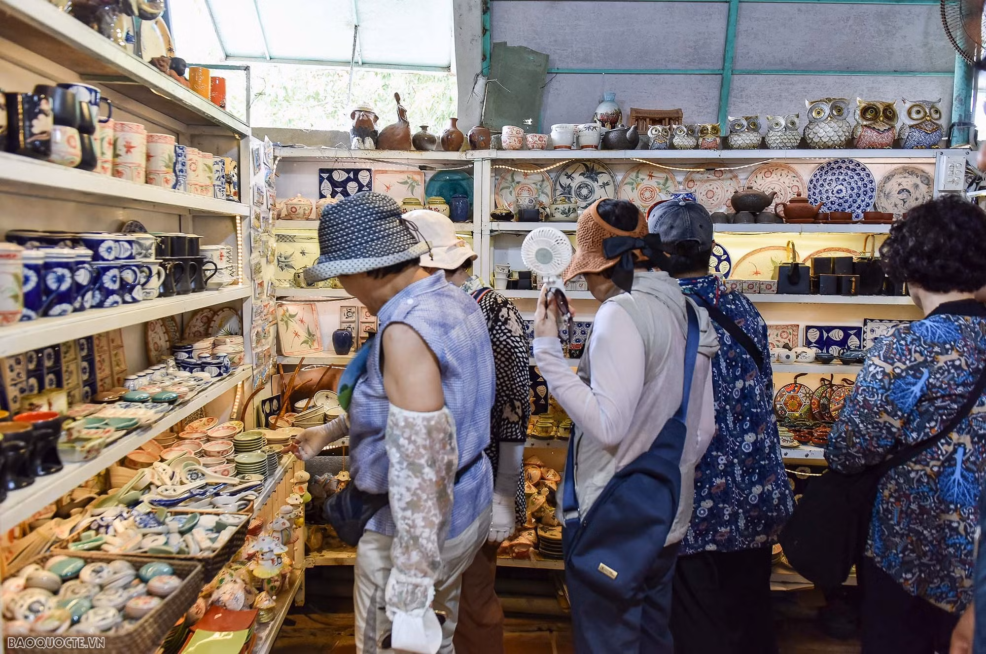 Turistas eligiendo suvenires en la aldea.