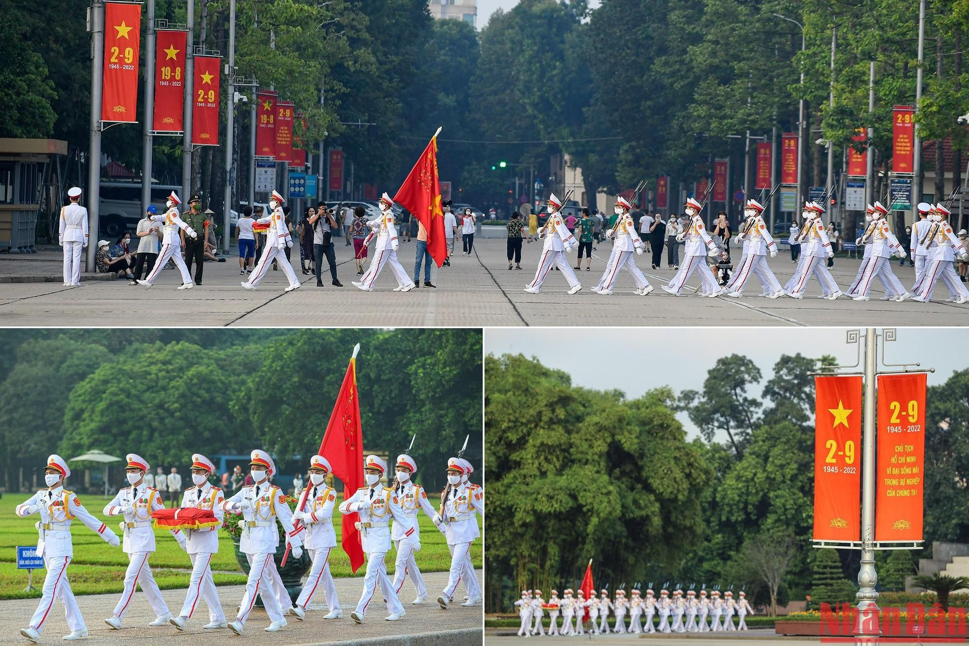 A las 6 menos cinco, con música militar de fondo, un pelotón de guardias entra en la plaza de Ba Dinh desde el cruce de las calles de Hung Vuong y Le Hong Phong. A las 6 menos cinco, con música militar de fondo, un pelotón de guardias entra en la plaza de Ba Dinh desde el cruce de las calles de Hung Vuong y Le Hong Phong.