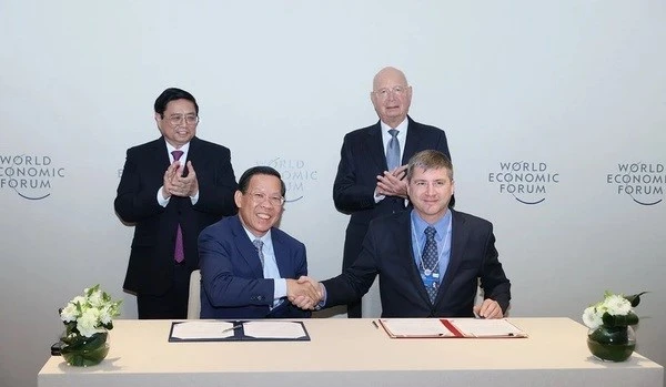 El primer ministro Pham Minh Chinh y el profesor Klaus Schwab, fundador y presidente ejecutivo del Foro Económico Mundial (FEM), presencian la firma de un memorando de cooperación entre el Comité Popular de Ciudad Ho Chi Minh y el FEM. (Foto: VNA)