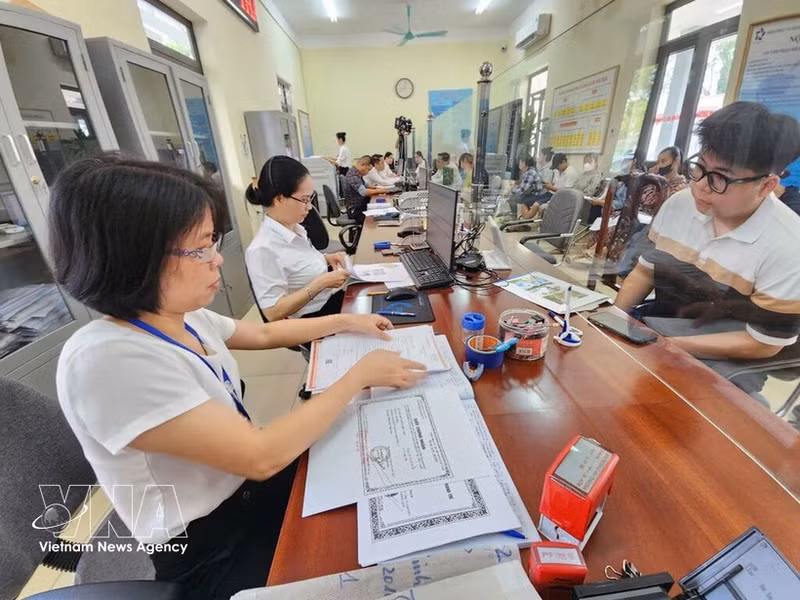 Ciudadanos realizan trámites administrativos en el Centro de Servicios Administrativos Públicos de la comuna de Thien Loc (Hanói). (Foto: VNA)