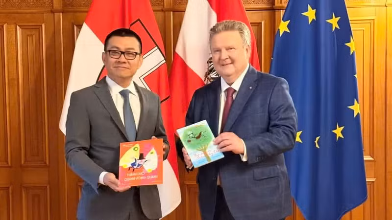 El embajador de Vietnam en Austria, Vu Le Thai Hoang, entrega al alcalde de Viena, Michael Ludwig, un ejemplar de la edición en vietnamita del libro infantil “La abuela en el manzano”, de la escritora austriaca Mira Lobe.