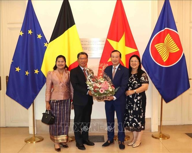 El embajador de Laos en Bélgica, Kingphokeo Phommahaxay (izquierda), entrega flores al embajador de Vietnam en el país europeo, Nguyen Van Thao. (Foto: VNA)