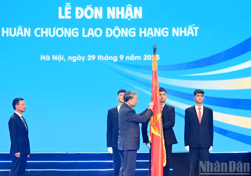 En nombre del Partido y del Estado, el secretario general del Partido Comunista de Vietnam, To Lam, otorga la Orden de Trabajo de primera clase al Ministerio de Ciencia y Tecnología por sus logros excepcionales. (Foto: Nhan Dan)